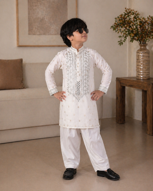 Child wearing a white embroidered kurta with pants