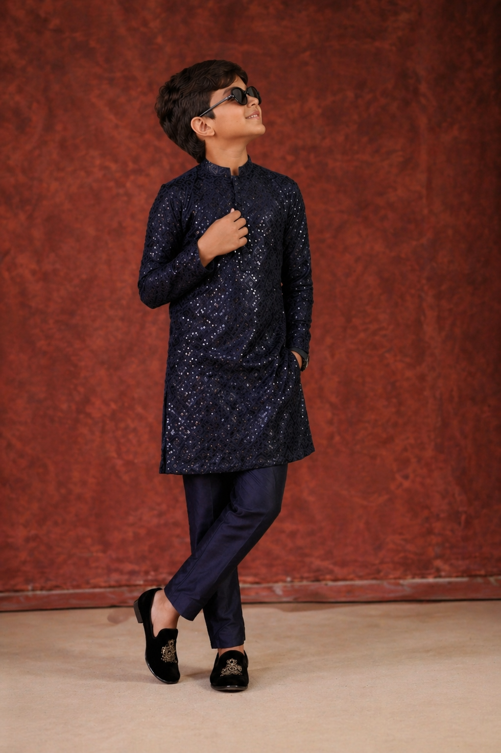 Child wearing a dark blue kurta with pants