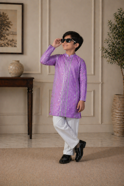 Child wearing a purple kurta with white pants