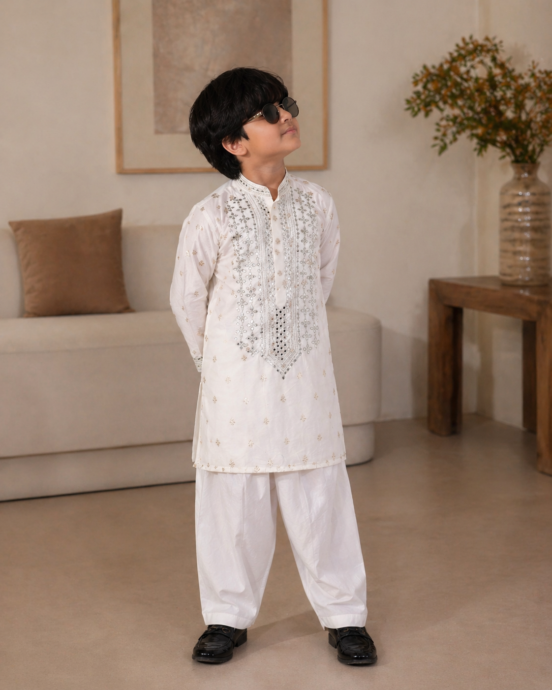 Child wearing a traditional white embroidered outfit