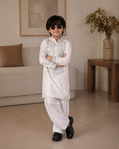 Child wearing a white embroidered kurta with sunglasses