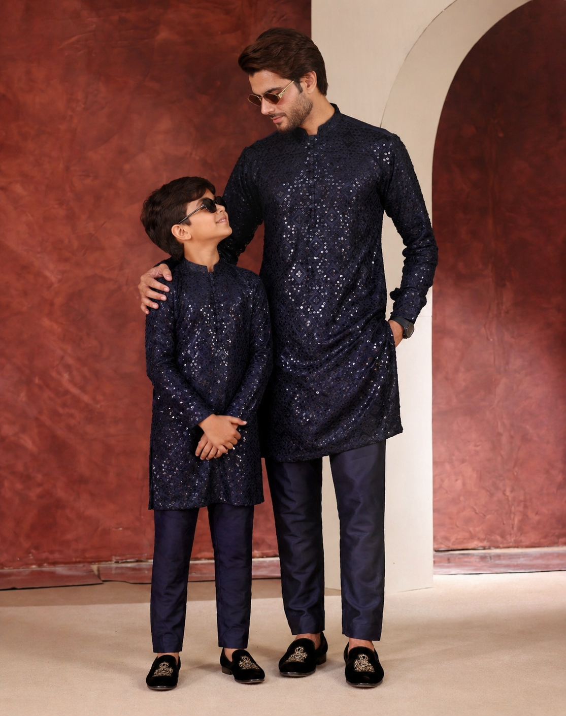 Father and Son in matching navy blue traditional outfits standing