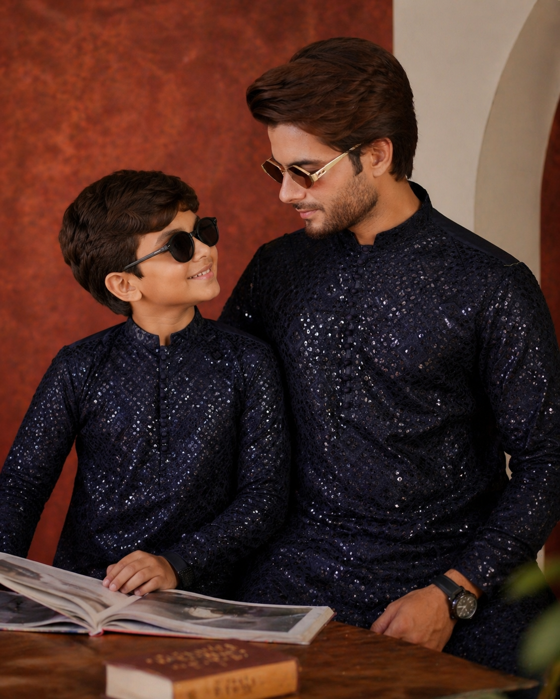 Man and child in matching dark blue sequined outfits