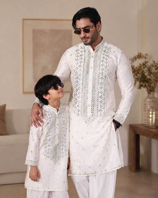 Father and Son wearing matching white traditional outfits