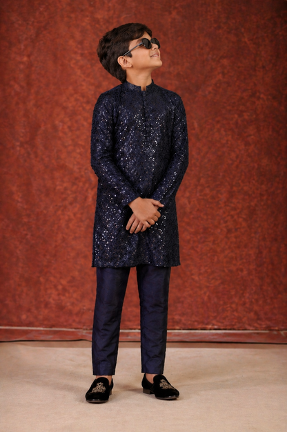 Young boy in a navy blue traditional outfit