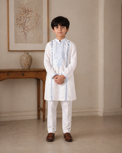 Young boy in a white traditional outfit