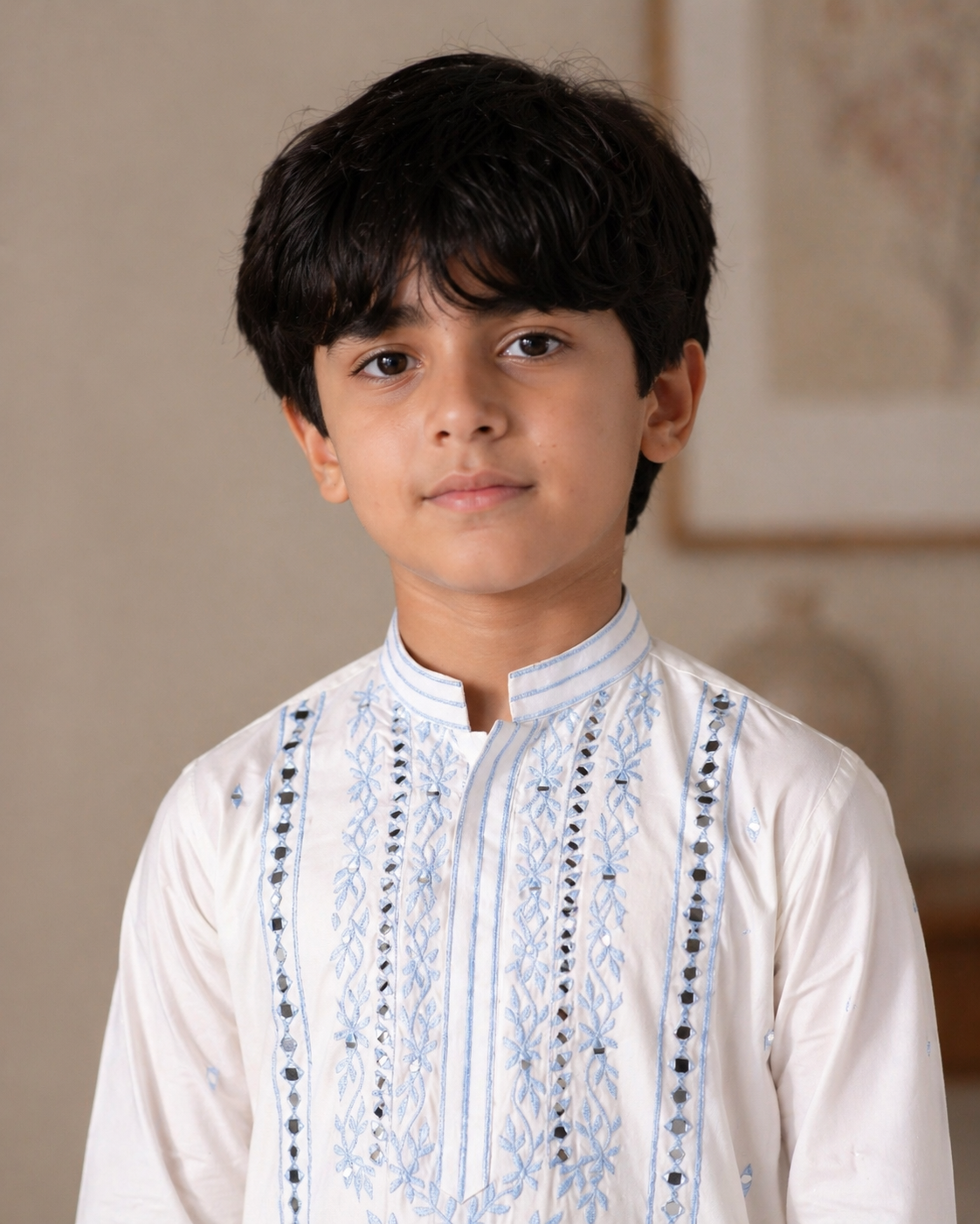 Young boy wearing a white embroidered shirt